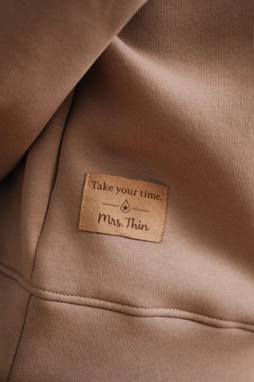 detal zamszowej metki TAKE YOUR TIME na plecach
